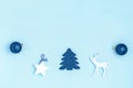 New Year and Christmas composition. Frame from blue balls, white stars, chrismas tree, deer and sparkles on pastel blue background Royalty Free Stock Photo