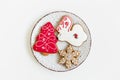 New year and christmas composition. gingerbread cookies on the plate. deer and tree shaped. white background Royalty Free Stock Photo