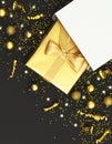 New Year or Christmas composition. Golden gift with ribbon from white paper bag, Christmas balls, confetti stars on black Royalty Free Stock Photo