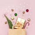 New Year Christmas composition. Paper bag and holiday decorations golden gift Christmas balls fir branches confetti Candy Cane on Royalty Free Stock Photo