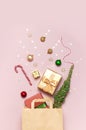 New Year Christmas composition. Paper bag and holiday decorations golden gift Christmas balls fir branches confetti Candy Cane on Royalty Free Stock Photo