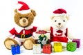 New year and Christmas concept.Couple teddy bear doll wearing santa set with many colorful gift boxes isolated on white background Royalty Free Stock Photo