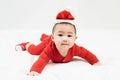 New year and Christmas concept with 5 months old cute newborn baby boy wearing christmas hat,red clothes lying on the bedsheet at Royalty Free Stock Photo