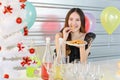 New year and Christmas Concept. Portrait of happy and smiling beautiful young asian woman holding and eating cookie in Xmas party Royalty Free Stock Photo