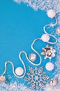 New year and Christmas decor in white and silver colors: balls, snowflake, bow, ribbon on a blue background under the Royalty Free Stock Photo