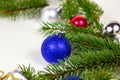 New Year and Christmas decoration with green fir tree branches and blue and silver shiny xmas traditional balls and baubles Royalty Free Stock Photo