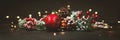 New Year and Christmas decoration, holiday background. Red festive ball bauble, green fir xmas tree and yellow blurred lights. Royalty Free Stock Photo