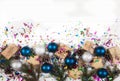 New Year and Christmas decoration made of fir branches, cones, beads, glitter and blue and silver balls on a white background. Royalty Free Stock Photo