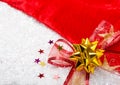 New Year and Christmas decorations for the holiday. Red bow, velvet and artificial snow Royalty Free Stock Photo