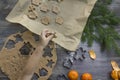 New Year and Christmas decorations on a wooden surface with tangerines and a Christmas tree. A small child puts ginger cookies in Royalty Free Stock Photo