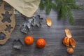 New Year and Christmas decorations on a wooden surface with tangerines and a Christmas tree. A small child puts ginger Royalty Free Stock Photo