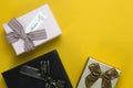 New Year and Christmas gift boxes concepts, and Realistic gifts boxes on yellow background, set of three gift boxes on top view Royalty Free Stock Photo