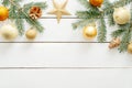 New year or Christmas golden decorations and fir tree branches on white wooden background. Flat lay, top view, copy space. Royalty Free Stock Photo