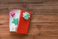 New Year, Christmas and Holiday Season Concept. Top view of beautiful red gift box with ceramic house toy and ornamenton old Royalty Free Stock Photo