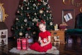 New Year 2020! Christmas, holidays and childhood concept - happy little girl with nutcracker and presents at christmas tree at hom Royalty Free Stock Photo