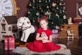 New Year 2020! Christmas, holidays and childhood concept - happy little girl with nutcracker and presents at christmas tree at hom Royalty Free Stock Photo