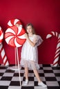 New Year 2020! Christmas, holidays and childhood concept. Merry Christmas, happy holidays! Little girl stands with a huge Christma Royalty Free Stock Photo