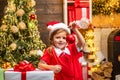 New year and Christmas kids concept. Child girl Decorating Christmas tree at home. Christmas toy - girl is decorating Royalty Free Stock Photo