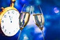 New Year or Christmas at midnight with champagne flutes make cheers blue bokeh and clock Royalty Free Stock Photo