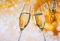 New Year or Christmas at midnight with champagne flutes make cheers, golden bokeh and clock Royalty Free Stock Photo