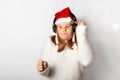 New Year and Christmas party, funny girl in santa hat is listening to music on headphones, isolated on a white background Royalty Free Stock Photo