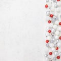 New Year or Christmas pattern flat lay top view Xmas holiday celebration decorative toy balls sparkles white concrete background Royalty Free Stock Photo