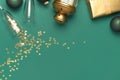 New Year Christmas presents, Christmas balls, champagne glasses, gold confetti stars on green background top view. Flat lay Xmas Royalty Free Stock Photo