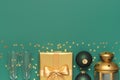 New Year Christmas presents, Christmas balls, champagne glasses, gold confetti stars on green background top view. Flat Royalty Free Stock Photo