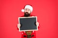 New year and Christmas publicity. Bearded man hold blank publicity board. Santa Claus display school publicity