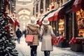 New Year Christmas shopping concept. Two female unrecognizable figures walk along a snowy street decorated with Royalty Free Stock Photo
