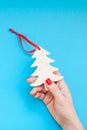 Woman hand holding homemade wooden christmas toy Royalty Free Stock Photo