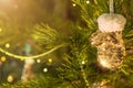 New Year and Christmas toy in a shape of golden mitten hanging on a Christmas tree surrounded by other toys. Royalty Free Stock Photo