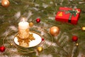 Christmas composition. Candle on the background of fir branches and a gift box. Royalty Free Stock Photo