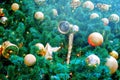 New year and Christmas tree decorations with Golden balls, candels and bells