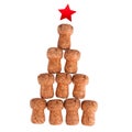 New Year or Christmas tree made of corks of champagne sparkling wine with red star on top, white background isolated close up