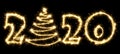 New Year 2020 with Christmas tree made by sparkler . Number 2020 and sign written sparkling sparklers . Isolated on a black Royalty Free Stock Photo