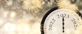 New Year 2023 clock and fireworks background.