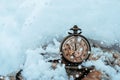 New year clock before midnight. Antique pocket watch in the snow