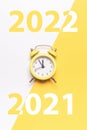 New year clock 2022. Retro style yellow clock in happy Christmas midnight. Countdown to happy xmas on yellow background Royalty Free Stock Photo