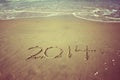 New Year 2014 is coming concept written on beach sand. vintage effect Royalty Free Stock Photo