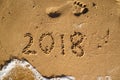 New Year is coming concept - 2018 written on a beach sand with w Royalty Free Stock Photo