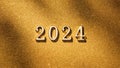 2024 new year coming. Golden numbers 2024 on gold glitter texture background