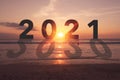New year 2021 is coming with sunset beach background. New start for planing or set new resolution in life Royalty Free Stock Photo