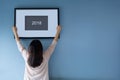 New year concept. Asian woman holding a picture frame of 2018 on Royalty Free Stock Photo