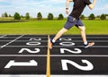 New year concept with black rubber running track with numbers, ideas of overcome year 2021 to coming year 2022. Start of racing, Royalty Free Stock Photo