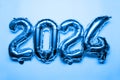 2024 New Year Concept - blue foil balloon and confetti Royalty Free Stock Photo