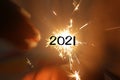 2021 New Year concept on blurry background of small fireworks in hand. Happy New Year.