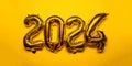 2024 New Year Concept - golden gold copper bronze foil balloon and confetti