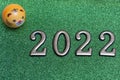 New year concept: golden numbers 2022 with tiger face on green glitter background with copy space Royalty Free Stock Photo