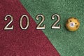 New year concept: golden numbers 2022 with tiger face on green-red glitter background with copy space Royalty Free Stock Photo